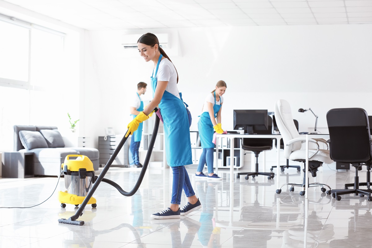 Team of janitors cleaning office